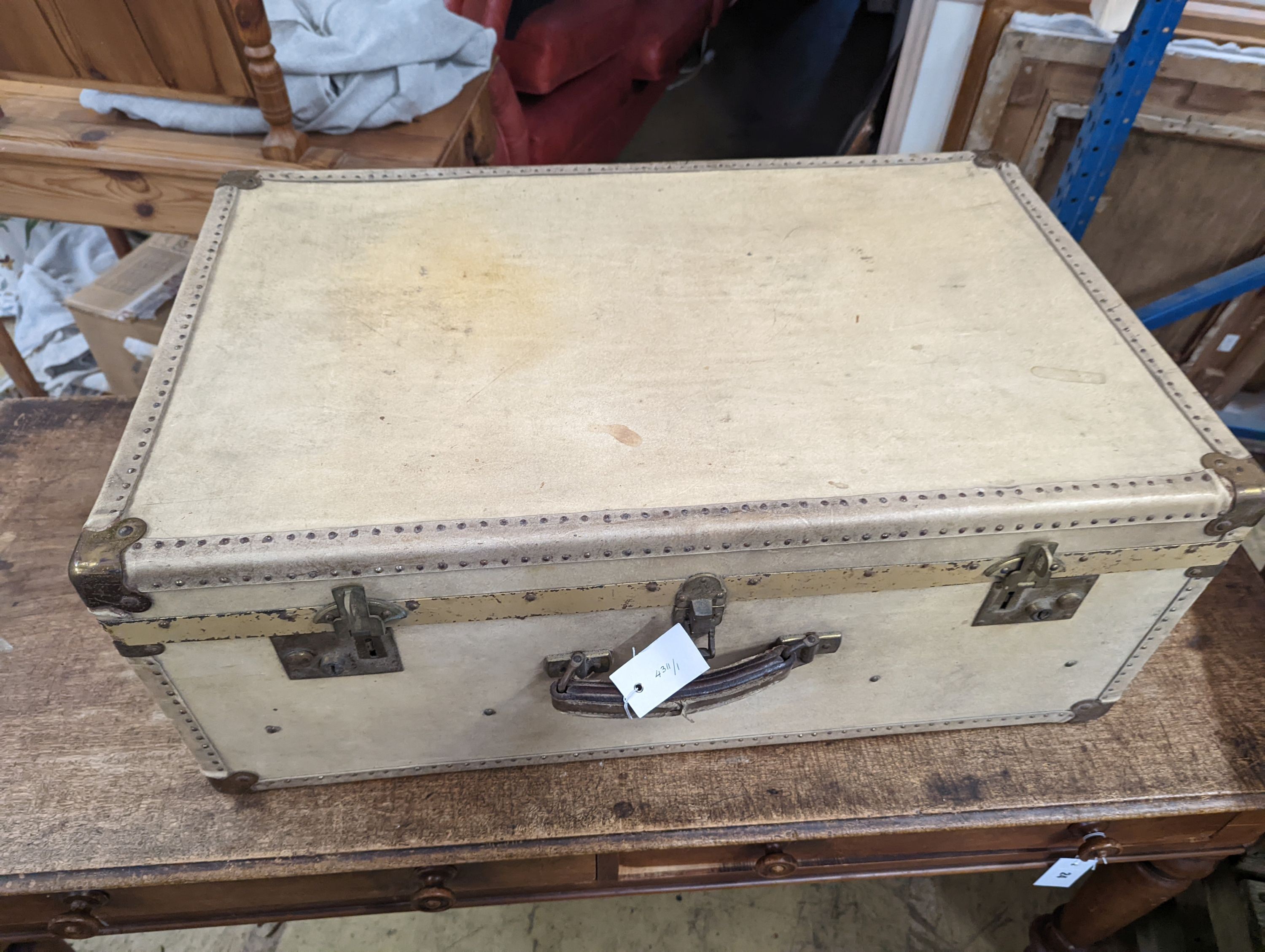An early 20th century brass mounted vellum suitcase, length 75cm, depth 48cm, height 30cm